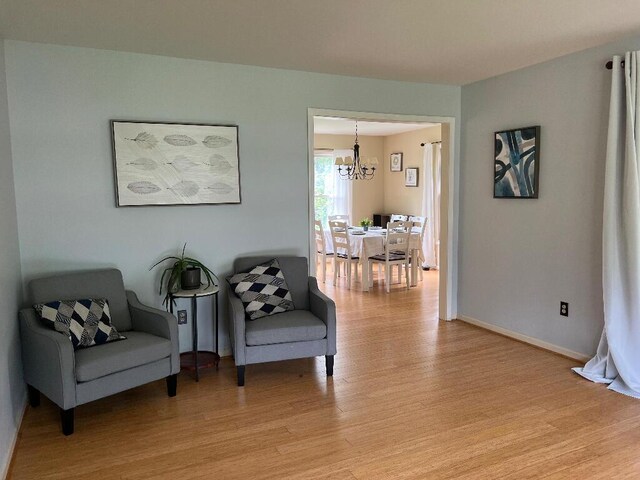 9220 Cotters Ridge Rd, Richland, MI 49083 - sitting room featuring a chandelier, light wood finished floors, and baseboards