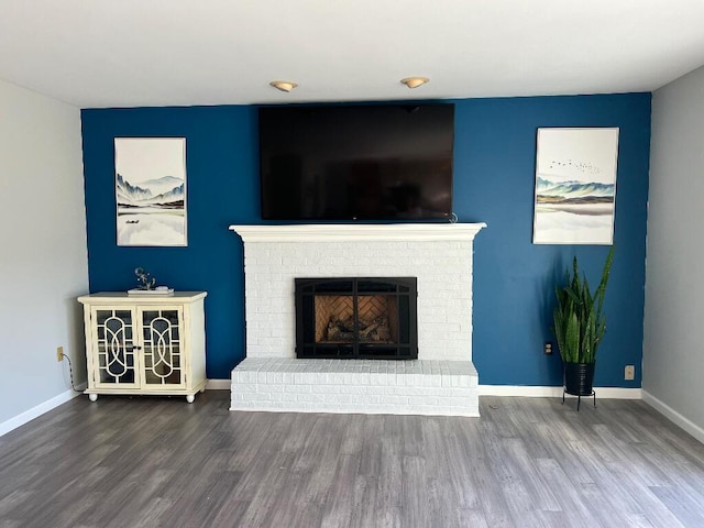 9220 Cotters Ridge Rd, Richland, MI 49083 - unfurnished living room with wood finished floors, a brick fireplace, and baseboards