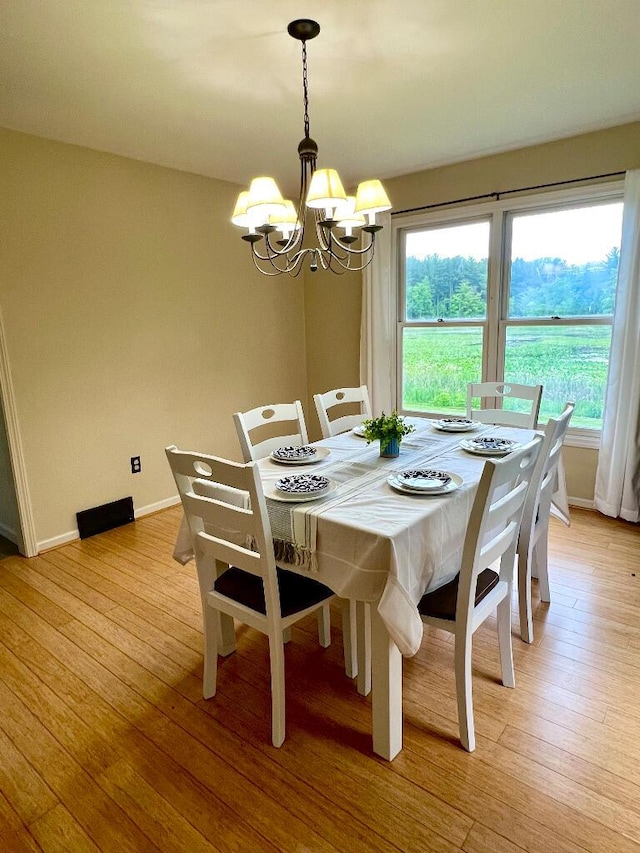 9220 Cotters Ridge Rd, Richland, MI 49083 - dining area with a chandelier, light wood-style floors, and baseboards