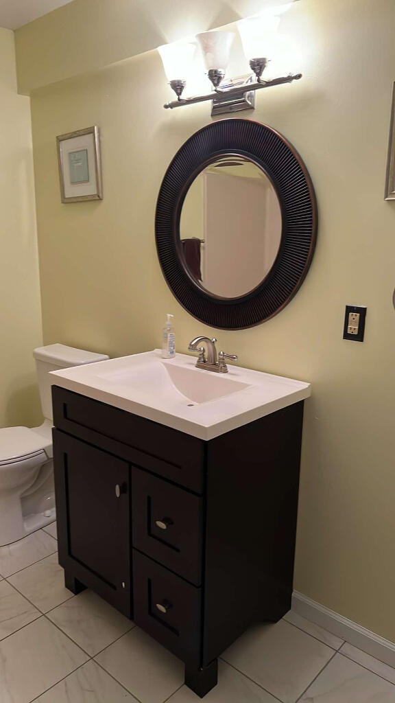 9220 Cotters Ridge Rd, Richland, MI 49083 - bathroom with vanity, toilet, marble finish floors, and baseboards