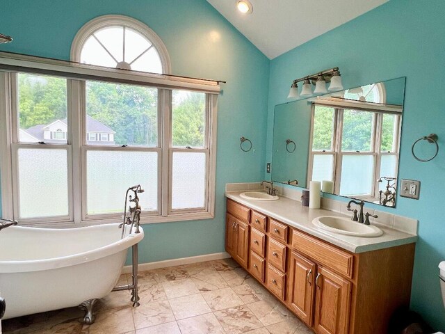 9220 Cotters Ridge Rd, Richland, MI 49083 - full bath with lofted ceiling, double vanity, a soaking tub, marble finish flooring, and toilet