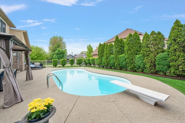 view of pool featuring a patio area, a diving board, a fenced backyard, and a gazebo