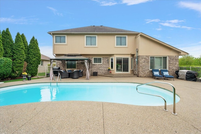 view of swimming pool featuring an outdoor hangout area, a gazebo, a patio, fence, and entry steps