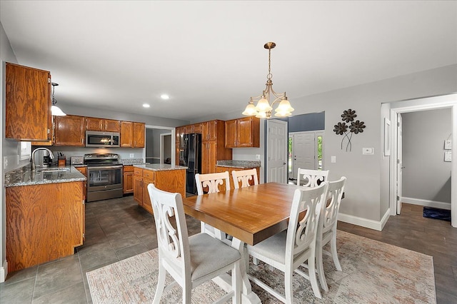 dining area featuring baseboards, recessed lighting, and a chandelier