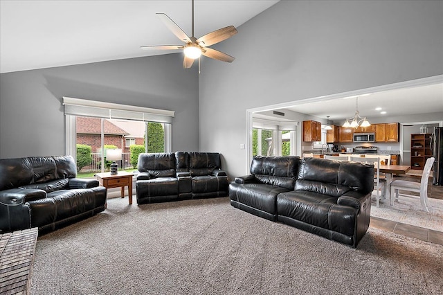 living area featuring high vaulted ceiling, a ceiling fan, plenty of natural light, and dark carpet