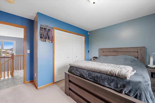 carpeted bedroom with baseboards and a closet