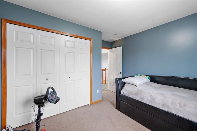 bedroom with carpet flooring, a closet, and baseboards