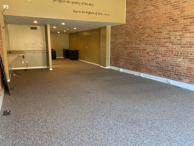 103 W Michigan Ave, Clinton, MI 49236 - carpeted empty room with brick wall and baseboards