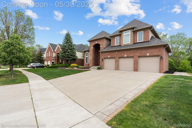 24516 Cavendish Ave E, Novi, MI 48375 - traditional-style house with brick siding, driveway, a front lawn, a shingled roof, and a garage
