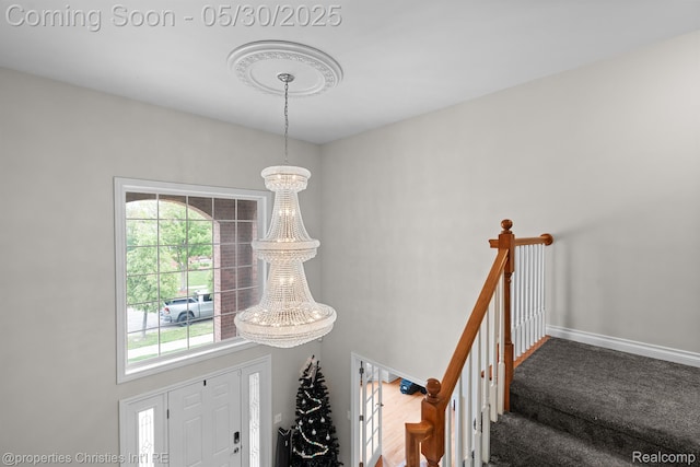 24516 Cavendish Ave E, Novi, MI 48375 - stairway with carpet floors, a chandelier, and baseboards