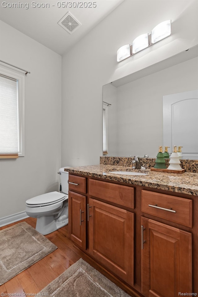 24516 Cavendish Ave E, Novi, MI 48375 - half bath featuring wood finished floors, vanity, and toilet