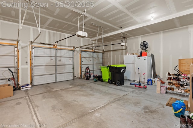24516 Cavendish Ave E, Novi, MI 48375 - garage featuring freestanding refrigerator and a garage door opener
