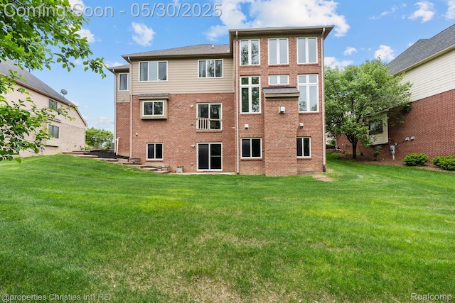 24516 Cavendish Ave E, Novi, MI 48375 - back of house featuring a yard and brick siding