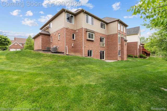 24516 Cavendish Ave E, Novi, MI 48375 - back of property with brick siding, a lawn, and cooling unit