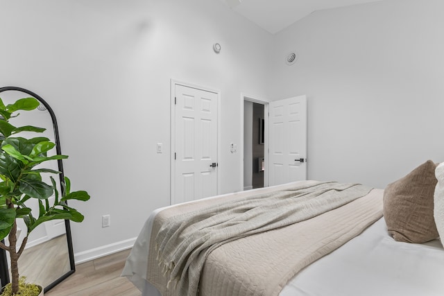 22432 Maple St, Saint Clair Shores, MI 48081 - bedroom featuring high vaulted ceiling, light wood-style flooring, and baseboards