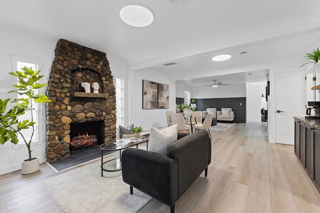 22432 Maple St, Saint Clair Shores, MI 48081 - living area featuring a ceiling fan, a fireplace, and light wood finished floors