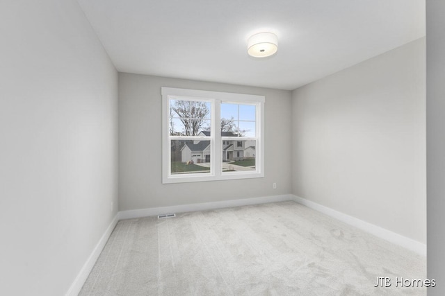 1404 Kimber Dr Unit 124, Lowell, MI 49331 - carpeted spare room featuring baseboards