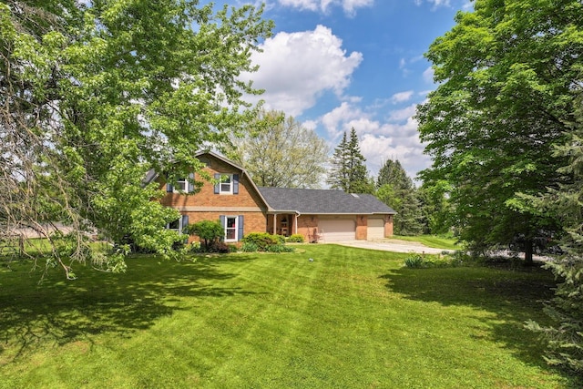 8277 Mccandlish Rd, Grand Blanc, MI 48439 - colonial inspired home with an attached garage, a front lawn, brick siding, and driveway