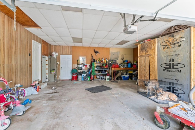 8277 Mccandlish Rd, Grand Blanc, MI 48439 - garage featuring a garage door opener and wooden walls