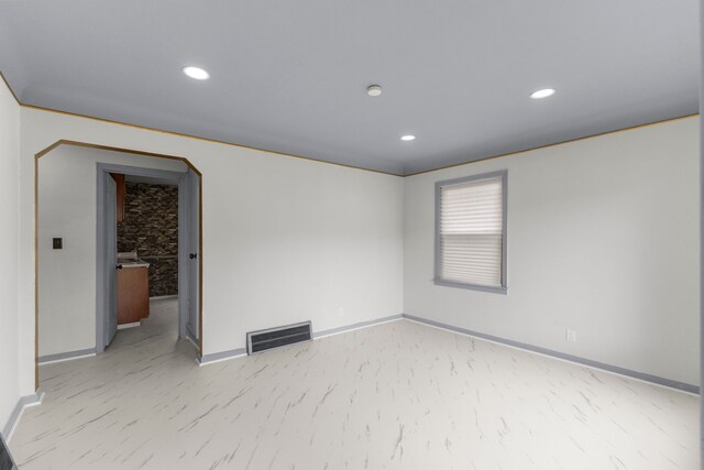 13734 Backus St, Southgate, MI 48195 - empty room with baseboards, recessed lighting, and arched walkways