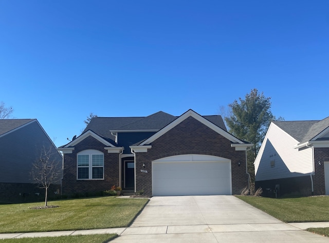 3048 Sheffield Cir, Clarkston, MI 48346 - view of front facade featuring a front lawn, driveway, brick siding, and an attached garage