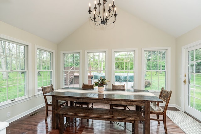 sunroom / solarium featuring lofted ceiling and a chandelier