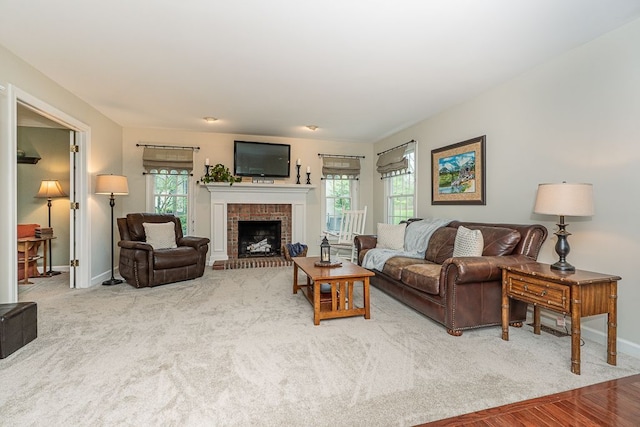 living room with baseboards and a brick fireplace