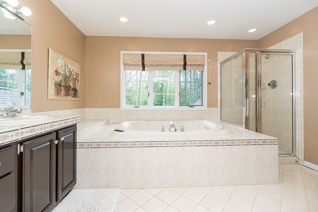 full bath with healthy amount of natural light, vanity, a bath, a shower stall, and recessed lighting