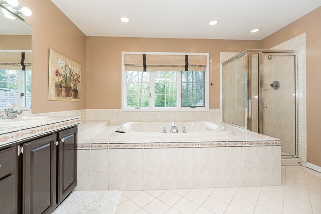 9079 Twin Oaks, Flushing, MI 48433 - full bath with healthy amount of natural light, vanity, a bath, a shower stall, and recessed lighting