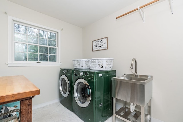 clothes washing area with independent washer and dryer, baseboards, and light marble finish floors