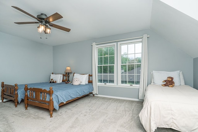 bedroom with carpet floors, vaulted ceiling, ceiling fan, and baseboards