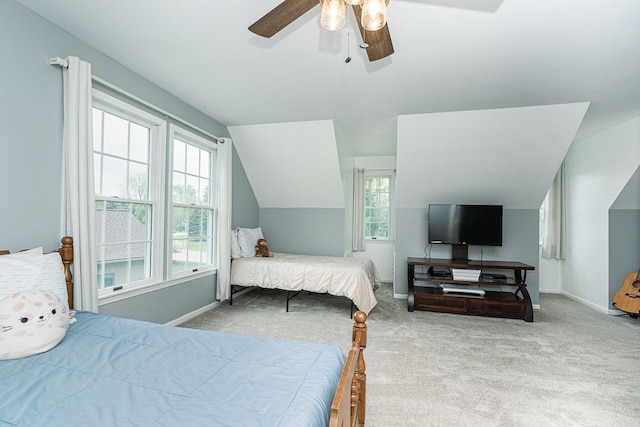 bedroom with carpet floors, vaulted ceiling, baseboards, and ceiling fan