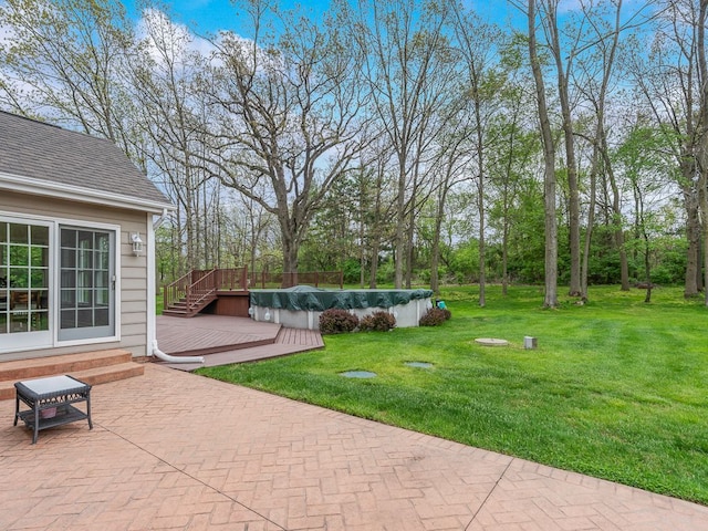 view of patio featuring a deck and a covered pool