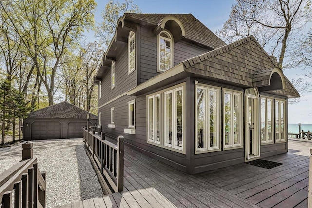 47130 Blue Star Hwy, Covert, MI 49043 - wooden terrace featuring a detached garage and an outdoor structure