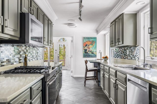 47130 Blue Star Hwy, Covert, MI 49043 - kitchen with appliances with stainless steel finishes, a sink, light countertops, ornamental molding, and tasteful backsplash