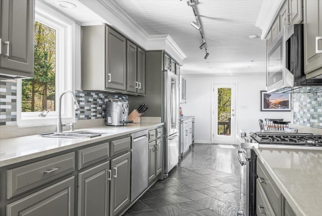47130 Blue Star Hwy, Covert, MI 49043 - kitchen with appliances with stainless steel finishes, gray cabinetry, a sink, and tasteful backsplash