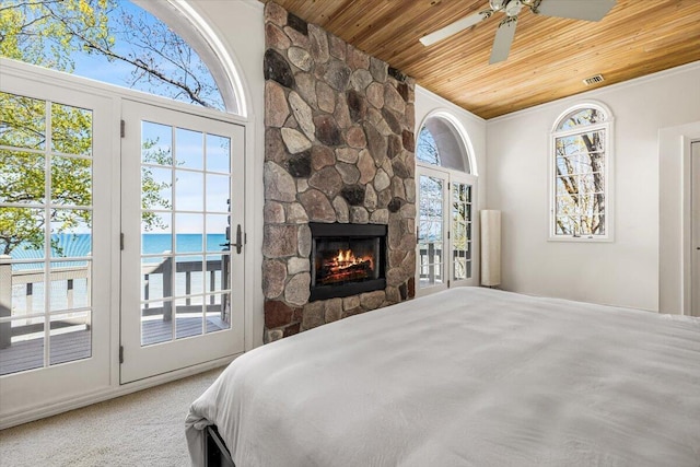 47130 Blue Star Hwy, Covert, MI 49043 - bedroom featuring wooden ceiling, access to exterior, a fireplace, and a water view