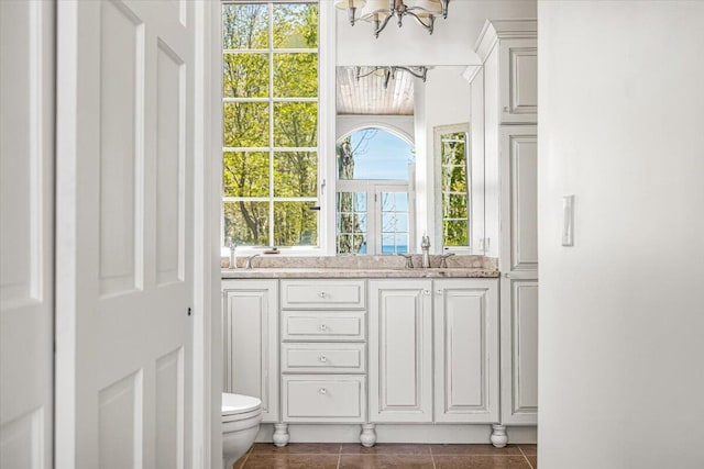 47130 Blue Star Hwy, Covert, MI 49043 - bathroom featuring a chandelier, tile patterned floors, toilet, and vanity