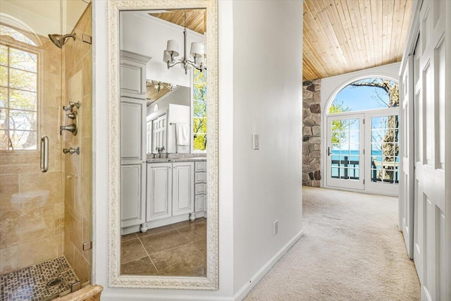 47130 Blue Star Hwy, Covert, MI 49043 - hallway with wooden ceiling, baseboards, light carpet, and a chandelier
