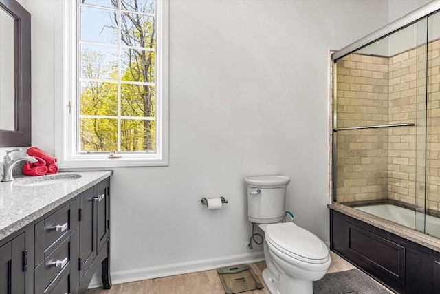 47130 Blue Star Hwy, Covert, MI 49043 - bathroom featuring toilet, vanity, shower / bath combination with glass door, and baseboards