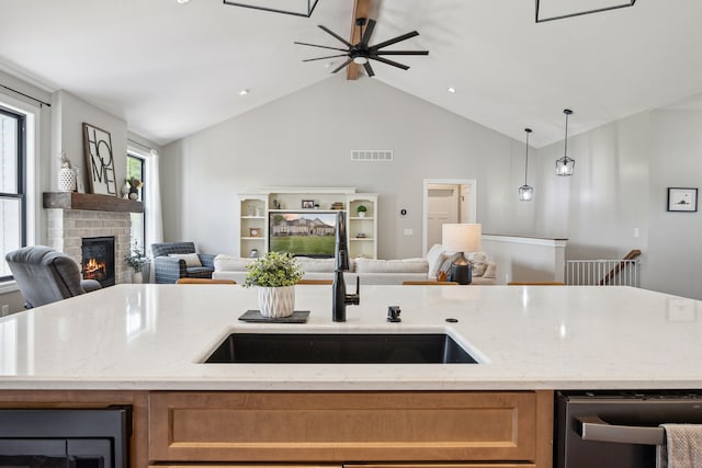 kitchen with open floor plan, a brick fireplace, dishwasher, beverage cooler, and lofted ceiling
