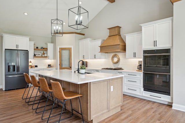 kitchen with fridge with ice dispenser, a sink, open shelves, tasteful backsplash, and custom range hood