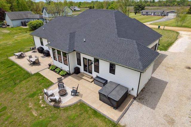 back of house featuring a fire pit, entry steps, a patio area, and a shingled roof