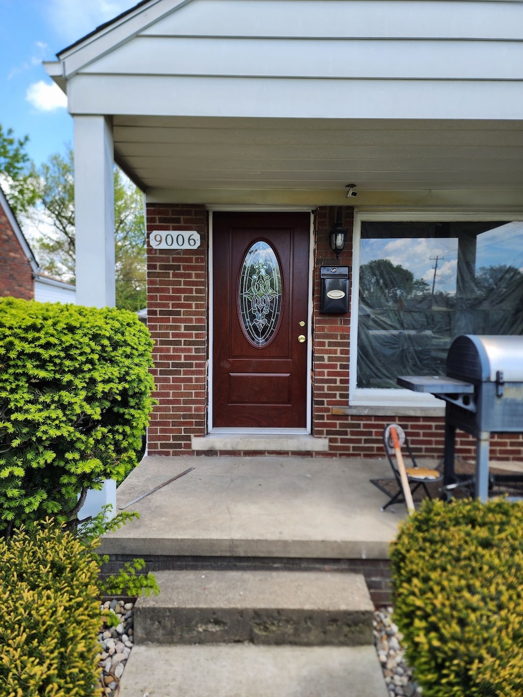 9006 Grandville Ave, Detroit, MI 48228 - property entrance featuring brick siding and a porch