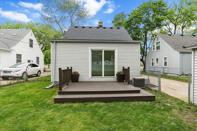 rear view of house featuring a wooden deck, central AC unit, and a chimney