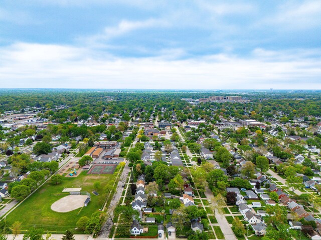 aerial view of property and surrounding area with nearby suburban area