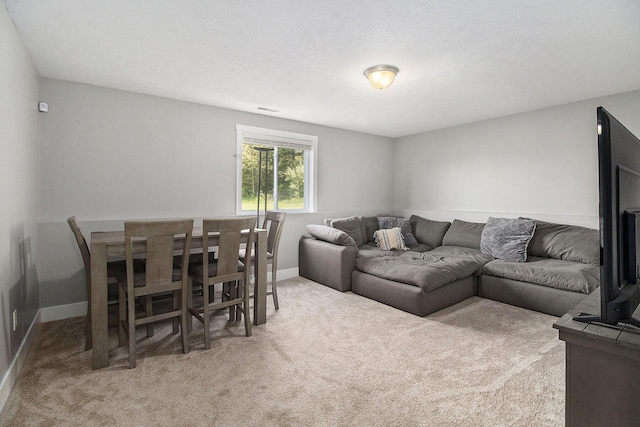 living room with carpet and baseboards
