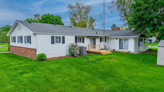6934 Colonial Dr, Tecumseh, MI 49286 - back of house featuring central AC unit, a wooden deck, a lawn, roof with shingles, and a chimney
