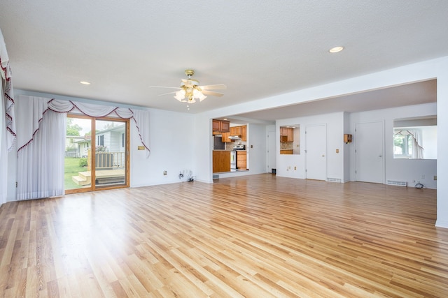 6934 Colonial Dr, Tecumseh, MI 49286 - unfurnished living room featuring a ceiling fan, light wood-style flooring, and recessed lighting
