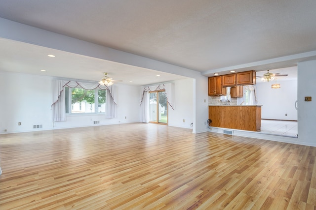 6934 Colonial Dr, Tecumseh, MI 49286 - unfurnished living room featuring ceiling fan, light wood-style flooring, recessed lighting, baseboards, and stairs